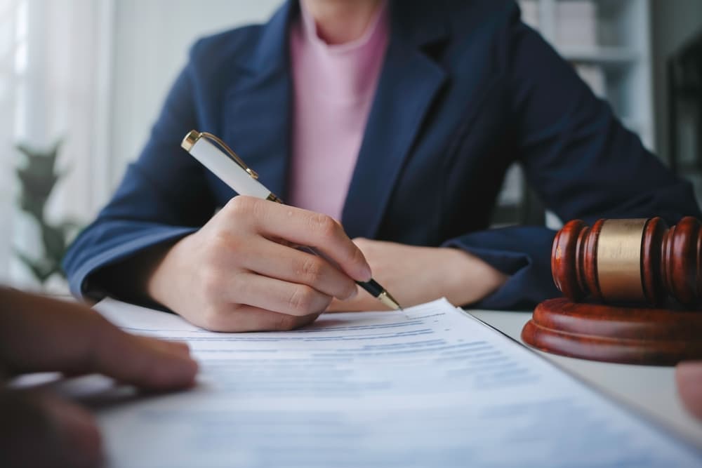 A female car accident lawyer working in office with gavel on the table
