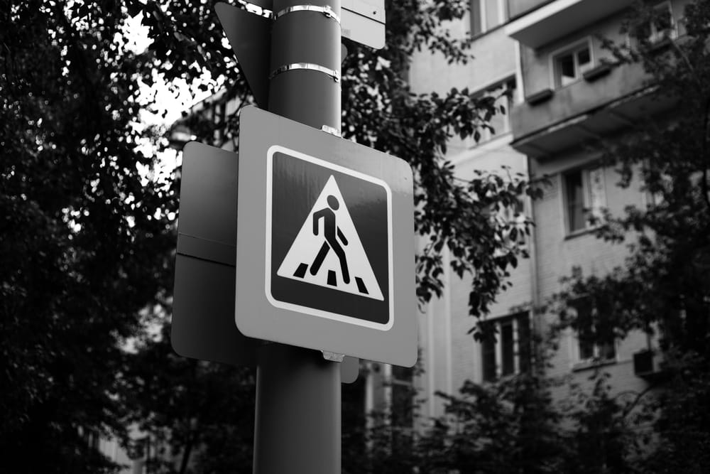 Pedestrian crossing sign near a Los Angeles intersection.