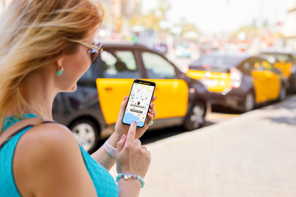 Person using a rideshare app while waiting for transportation in Los Angeles.
