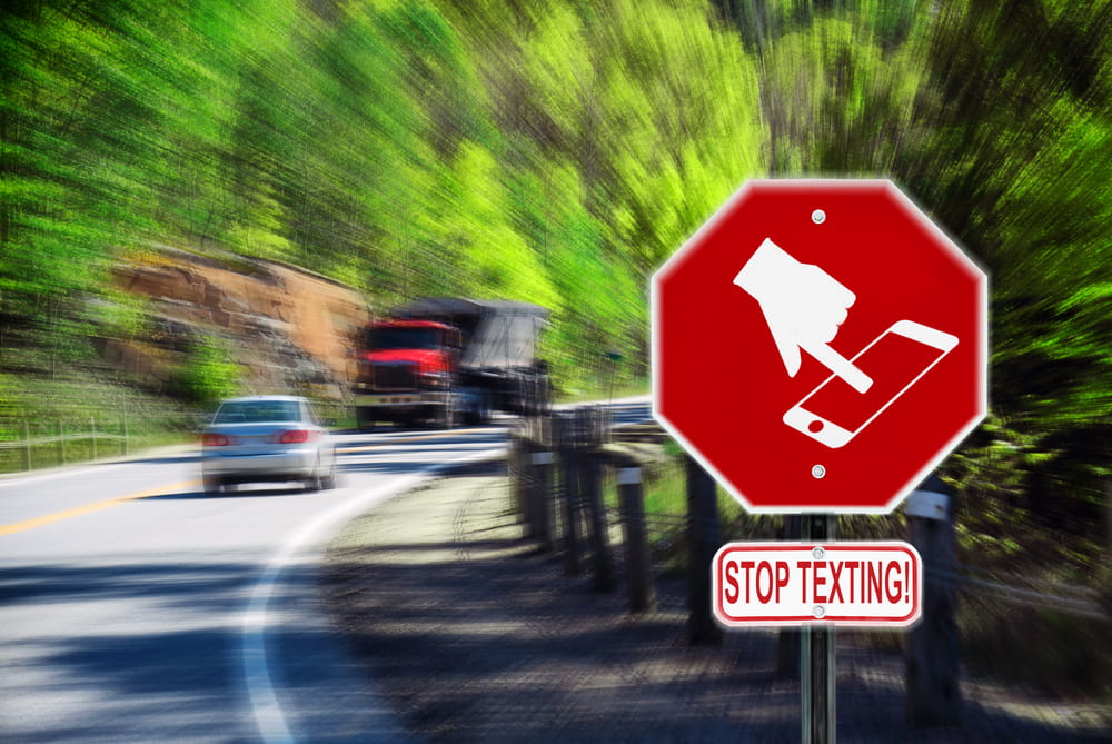 Roadside stop texting sign warning drivers about distracted driving dangers in Los Angeles.