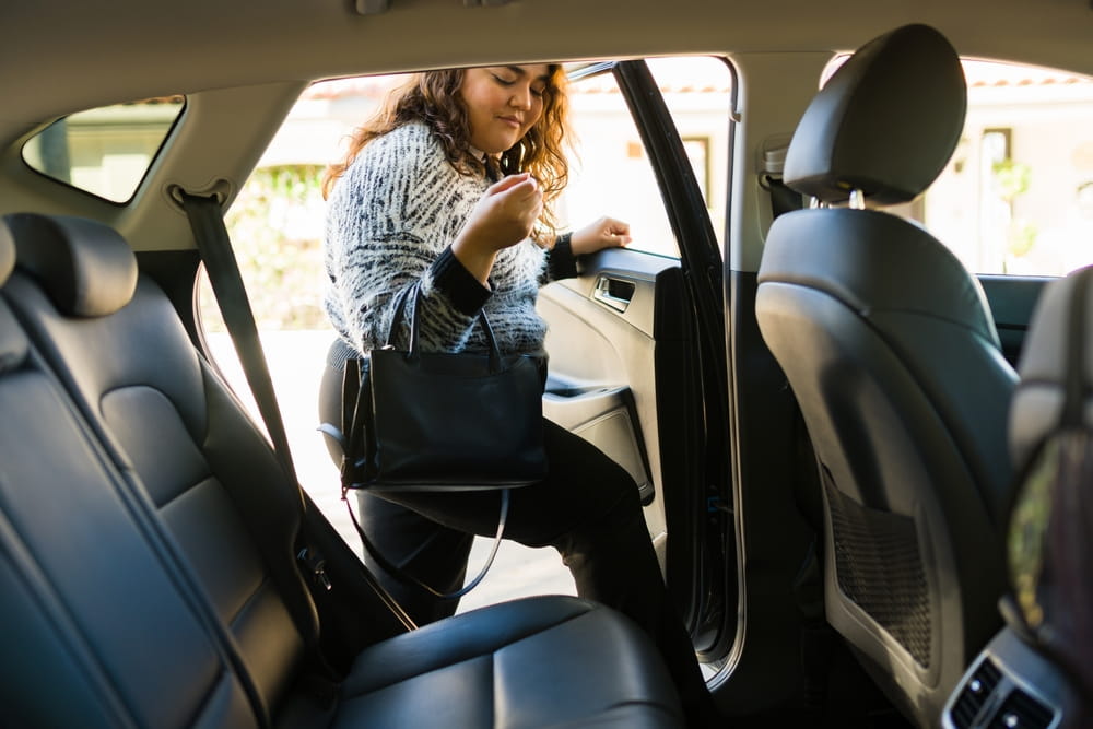 Passenger entering a rideshare vehicle in Los Angeles.